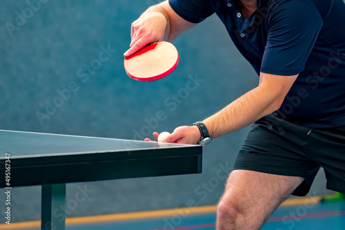 table tennis player serving, focus at the ball