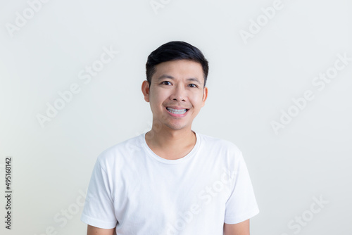 Positive human facial expressions and emotions/The smiles and happy faces of Asian men presenting a white background / advertising model concept