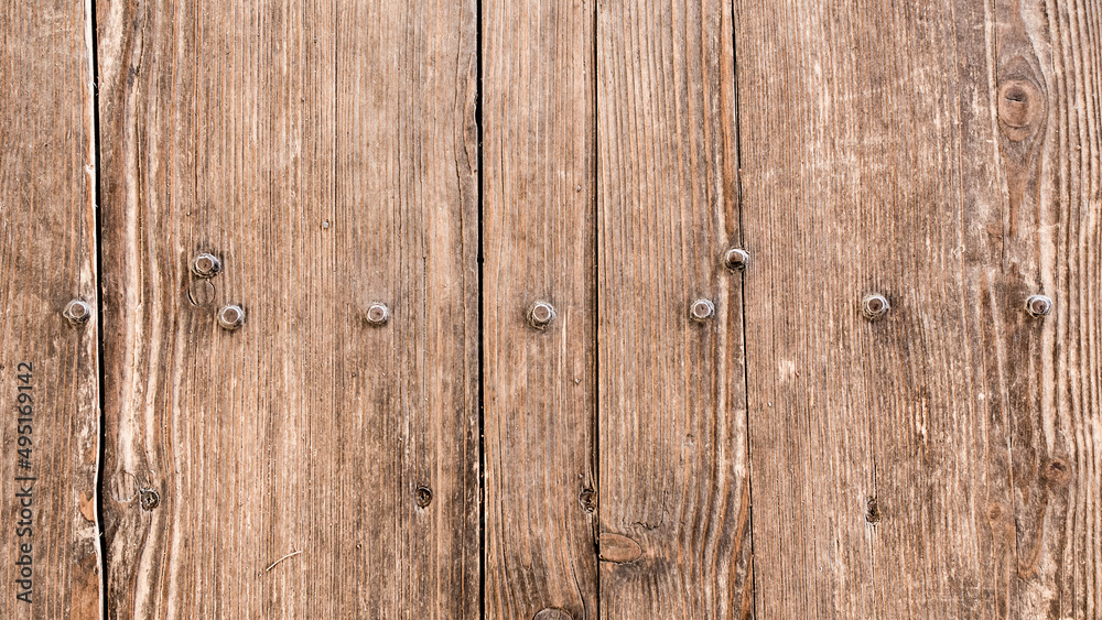 An old wooden floor is held together with screws.
An old wooden floor is held together with screws.