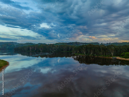 Sunrise reflections and clouds at the seaside with lagoon