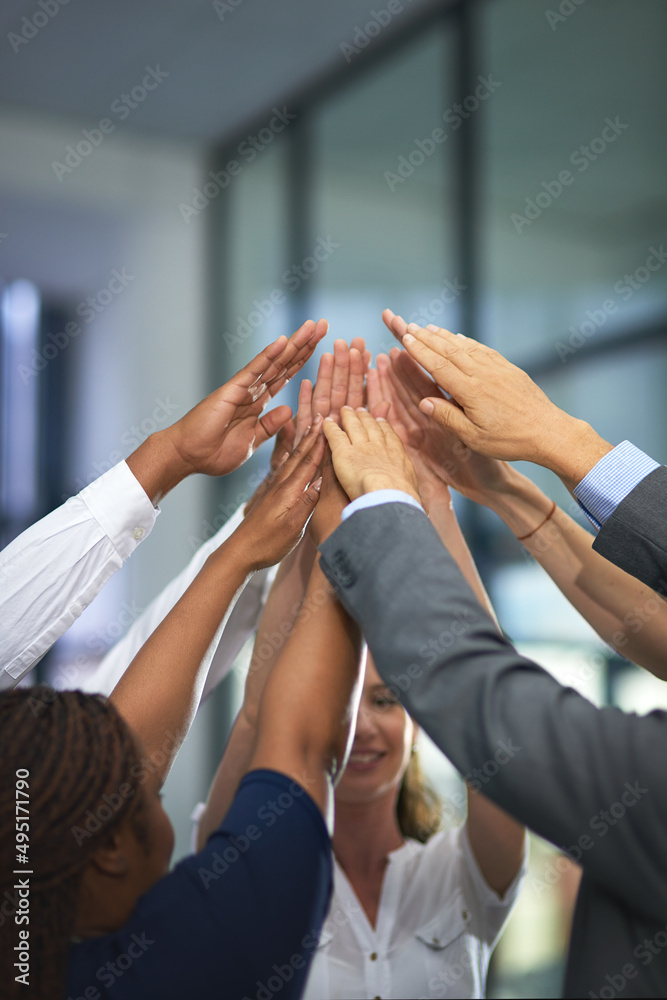 Go team. Shot of a group of unrecognizable businesspeople with their hands in a huddle.