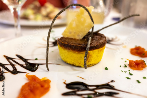 Cuisine of EmiliaRomagna region, baked Italian parmesan sformato or flan made with grated Parmigiano Reggiano cheese from Parma and served with balsamic vinegar of Modena photo