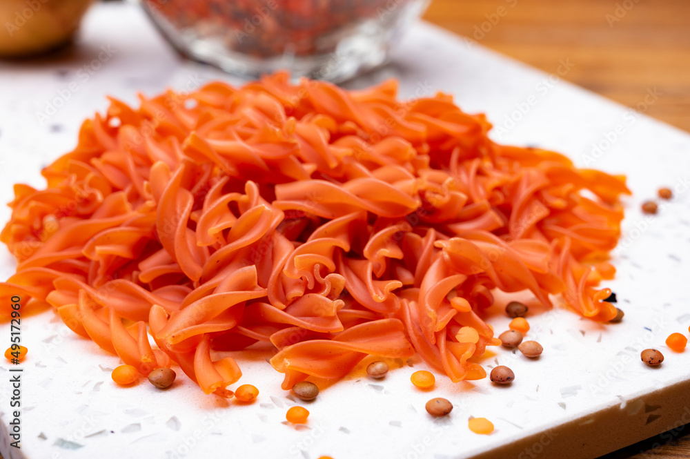 Vegan gluten free and vegetarian food, dried spiral pasta made from orange lentils legumes Vegan gluten free and vegetarian food, dried spiral pasta made from orange lentils legumes