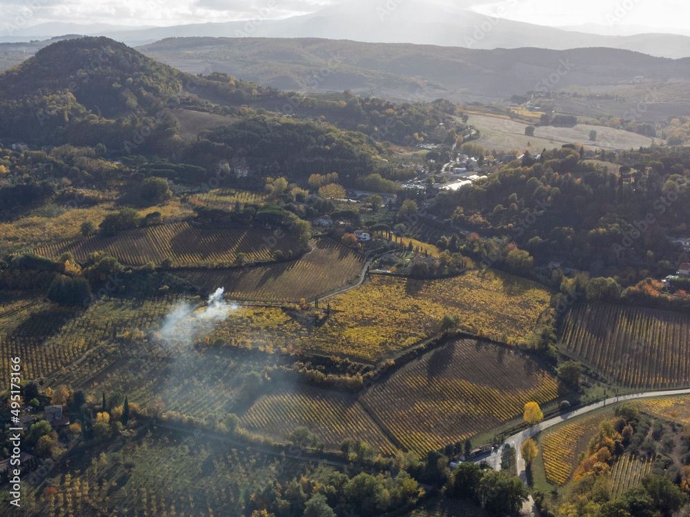 Naklejka premium Aerial view on hills witn vineyards near old town Montepulciano, Tuscany, Italy