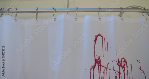 Medium shot of blood spraying on a shower curtain.