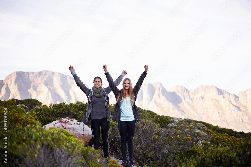 We made it to the top. Portrait of two excited young female hikers in the outdoors.