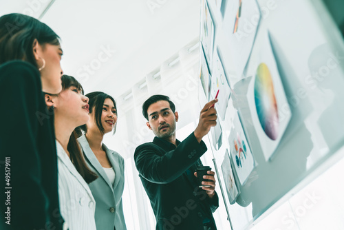 Business people proficiently discuss work project while sitting in circle . Corporate business team collaboration concept . photo