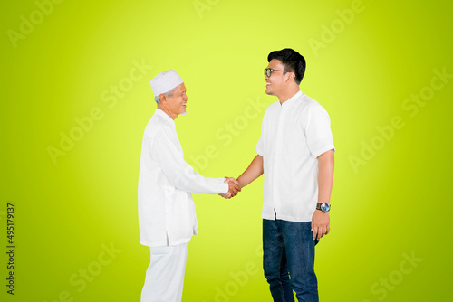 Young man handshake with his father on studio