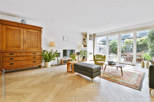 Bilde på lerret A magnificent large living room with a gray sofa and a green armchair