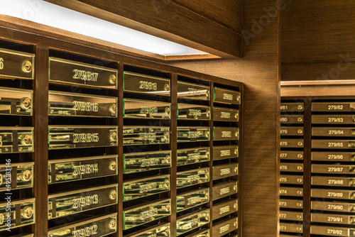 Mailboxes in apartment postal room with warm light decoration. Communication and business concept.