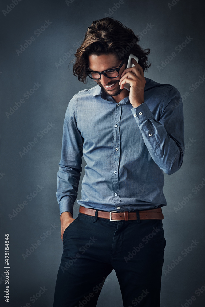 We should go see a movie sometime. Studio shot of a handsome young man talking on his cellphone while standing against a grey background. We should go see a movie sometime. Studio shot of a handsome young man talking on his cellphone while standing against a grey background.