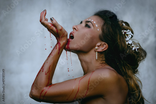 lamorous photos of wild woman showing blood and gore dripping from the mouth