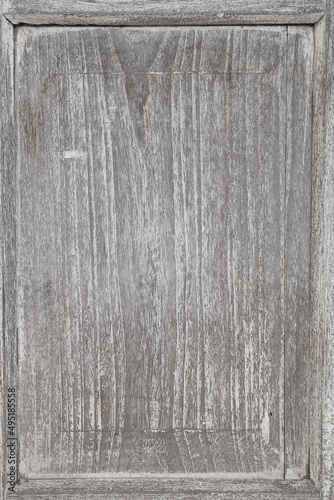 Detail of old gray wooden background of weathered distressed rustic wood with faded white paint showing woodgrain texture