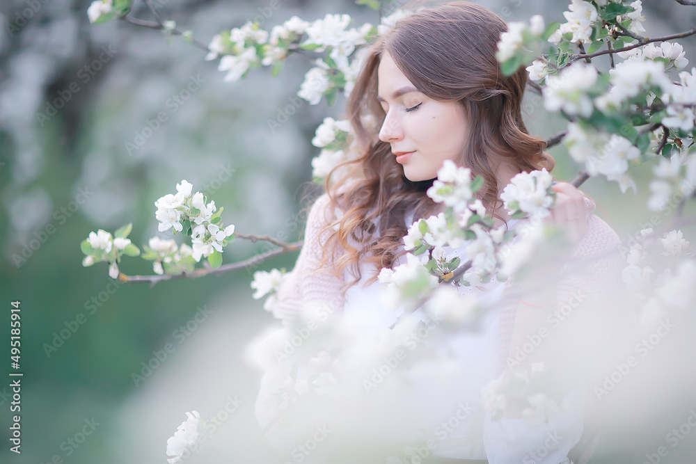 springtime fashion portrait of a young girl in a blooming cherry garden, tenderness of the morning springtime fashion portrait of a young girl in a blooming cherry garden, tenderness of the morning