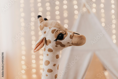 Photography Children's plush toy giraffe on the background of garlands