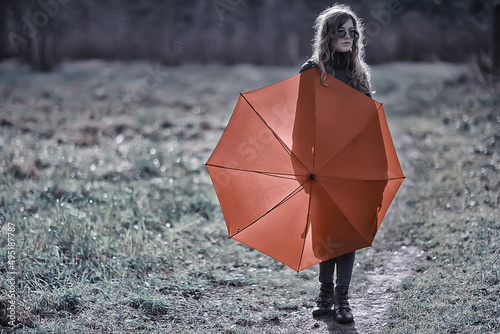 seasonal autumn portrait  sad girl with umbrella  november seasonal virus immunity on a walk