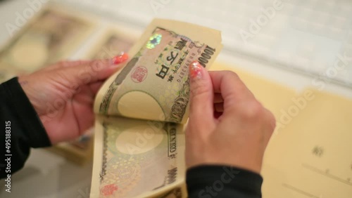 Japanese  office worker counting money