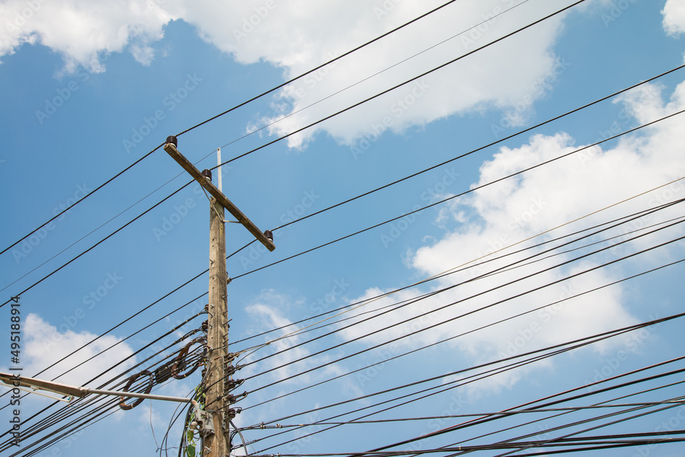 Electric pole transmission power line with blue sky background. Electrical energy and technology concept. Electric pole transmission power line with blue sky background. Electrical energy and technology concept.