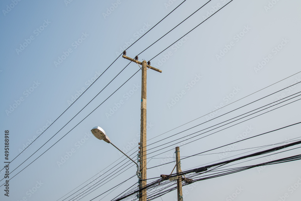 Electric pole transmission power line with blue sky background. Electrical energy and technology concept.