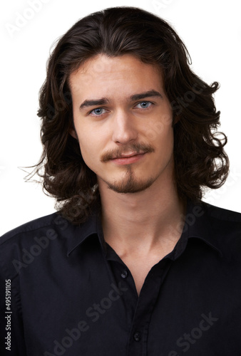 Giving you that dreamy smile. Handsome young man with shoulder-length hair and a goatee smiling at the camera.