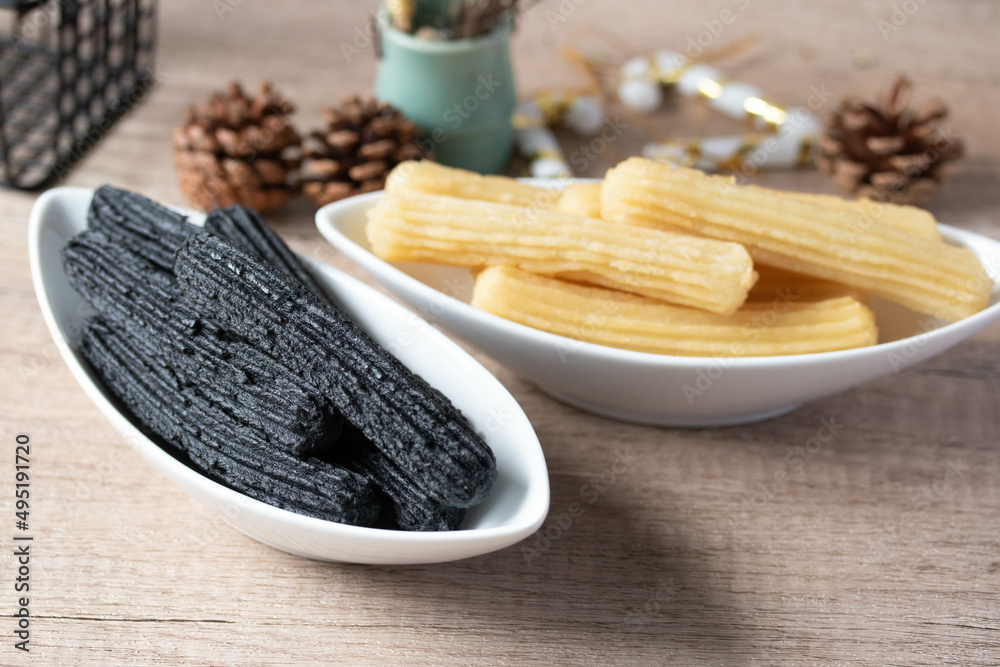 churros sticks typical of Spain with charcoal and vanilla Stock Photo