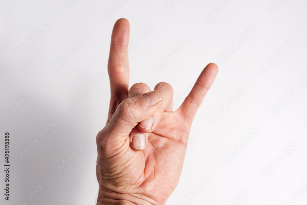 Hand on a white background two fingers index and little finger show up Hand on a white background two fingers index and little finger show up