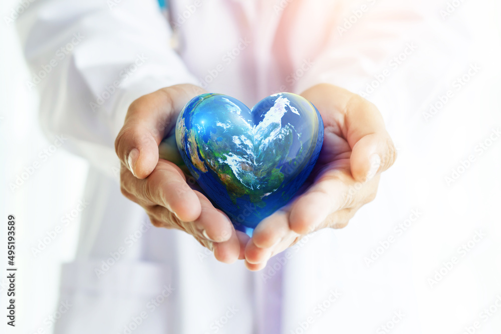Hands hold Earth ball in heart shape on Doctor hands for World