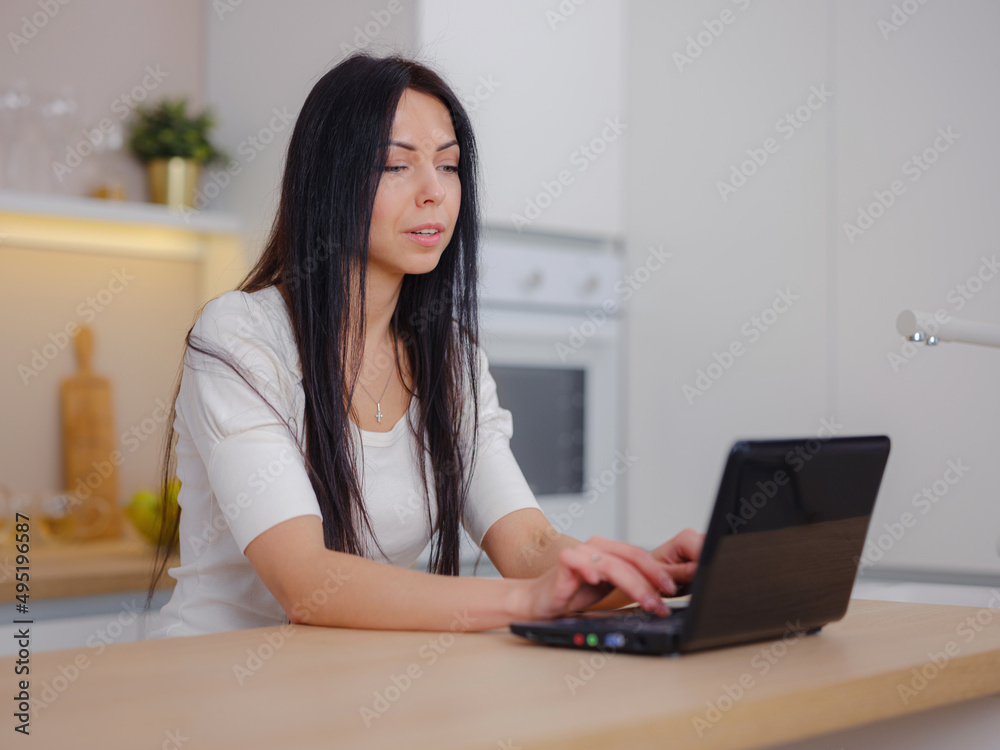 smiling young woman looking at laptop screen, reading good news in message, watching video, chatting in social network or shopping online at home, enjoying leisure time with computer smiling young woman looking at laptop screen, reading good news in message, watching video, chatting in social network or shopping online at home, enjoying leisure time with computer