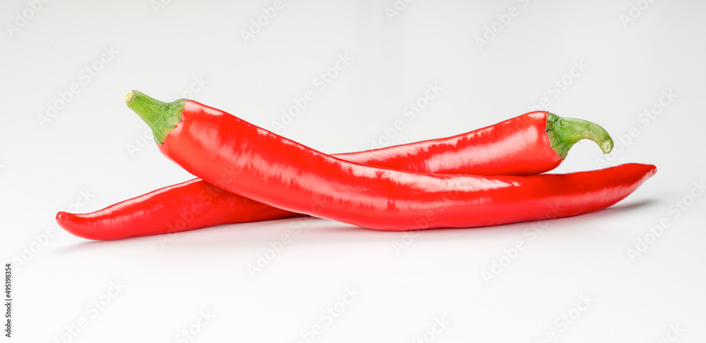two Ripe chili pepper isolated on white background. red hot chili pepper. Red Cayenne pepper. Red long chili peppers. high-quality studio shot of red long capsicum, no dust