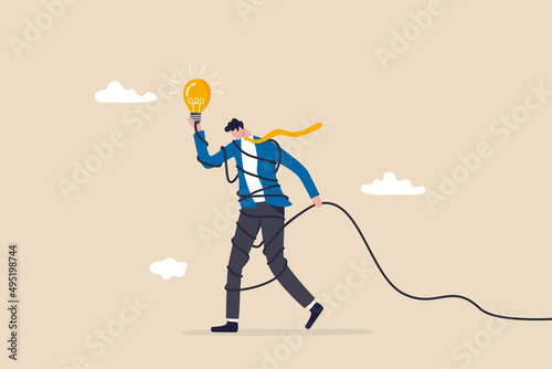 Solving complex problem, difficult idea or complicated solution, challenge or contemplation to overcome difficulty concept, frustrated businessman holding lightbulb idea while try to solve messy knot.