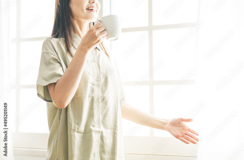 ホットドリンクを飲むミドル世代の女性
ホットドリンクを飲むミドル世代の女性