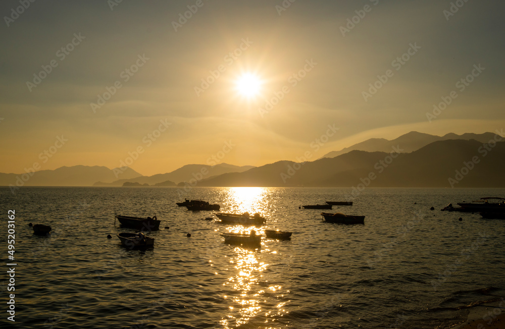 Sunset in Peng Chau, featuring boats moored at the sea