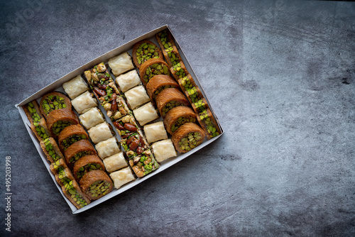 Arabic and Turkish oriental sweets Desserts made of pistachios and kunafa with leafy dough photo