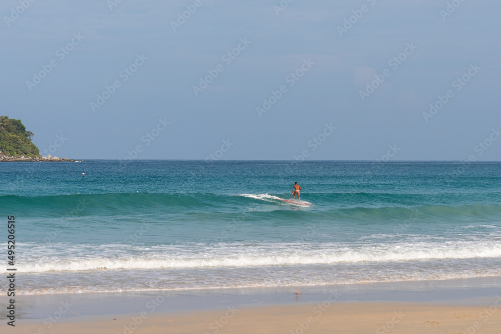 Identified surfer are surfing at Kata Beach
