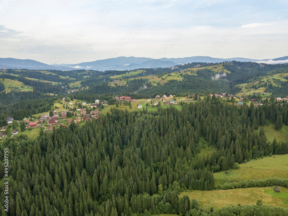 Naklejka premium Green mountains of Ukrainian Carpathians in summer. Aerial drone view.