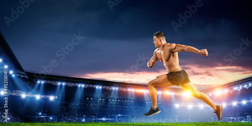Male runner against stadium . Mixed media © Sergey Nivens