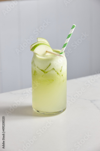 Vertical shot of glass of green soda photo