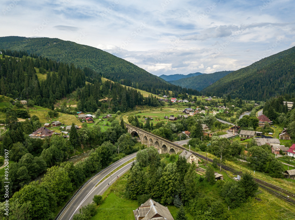 Old railway bridge in the mountains. Ukrainian Carpathians. Aerial drone view.