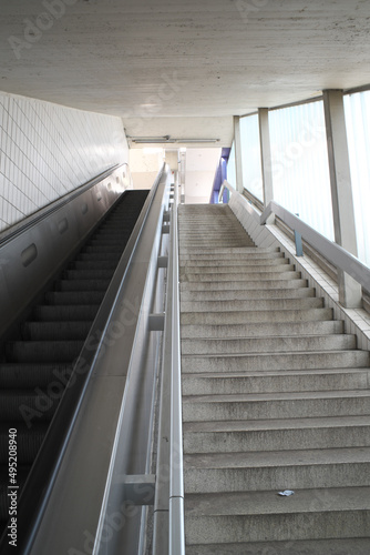 Escalator and stairs seen parallel side by side upwards 