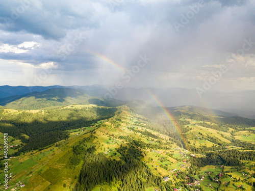 Rainbow in the mountains of the Ukrainian Carpathians. Aerial drone view.