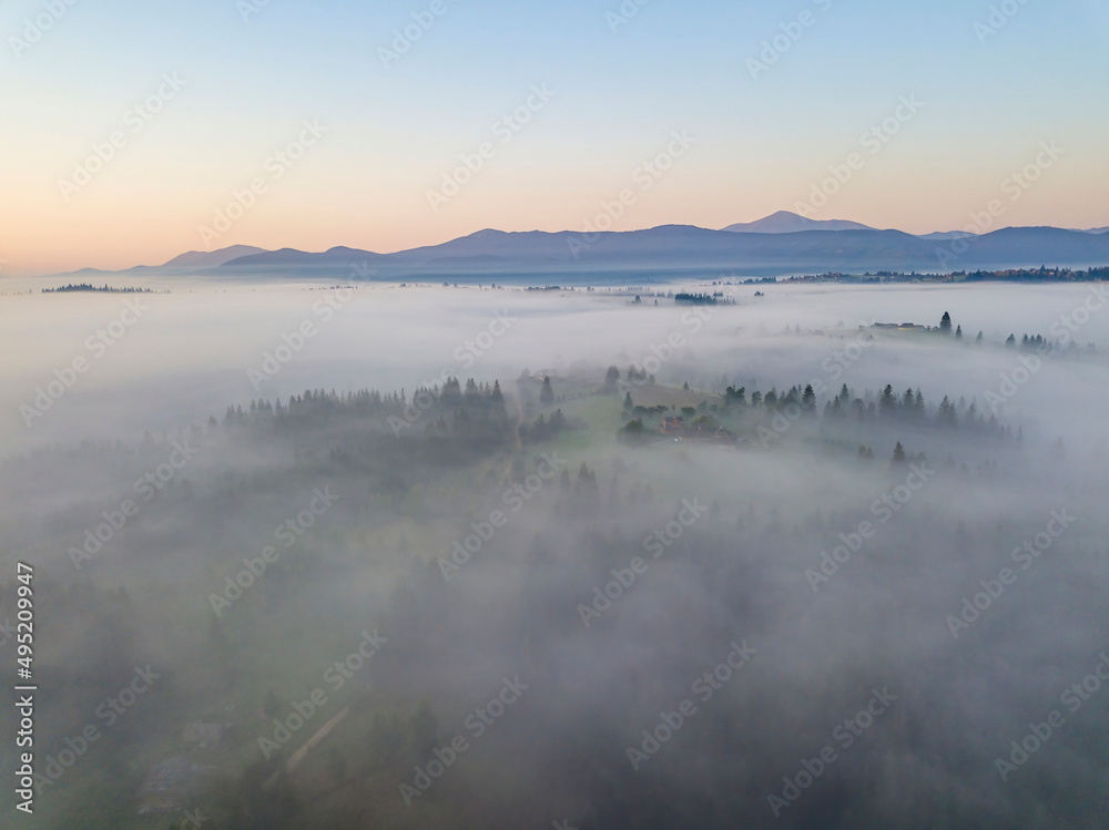 Morning fog in the Ukrainian Carpathians. Aerial drone view.