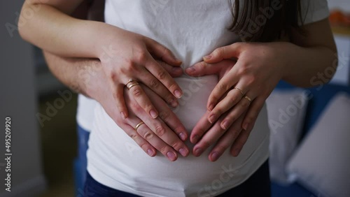 Wallpaper Mural Loving young husband and wife make heart sign hugging pregnant belly Torontodigital.ca