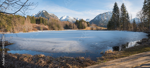 frozen lake Moorweiher, hiking desitnation near Oberstdorf, allgau alps in march photo