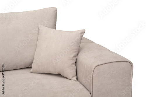 Fragment of a beige sofa with pillows on a white background, isolated, close-up