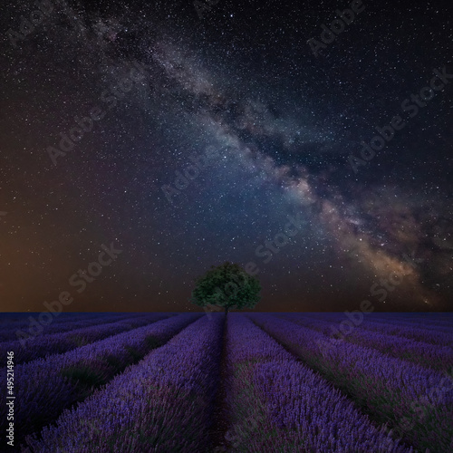 Vibrant Milky Way composite image over landscape of Beautiful lavender field
