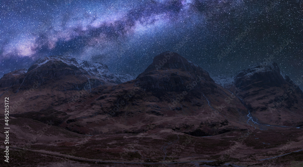 Majesitc vibrant Milky Way composite image over landscape of Three Sisters mountains in Glencoe in Scottish Highlands