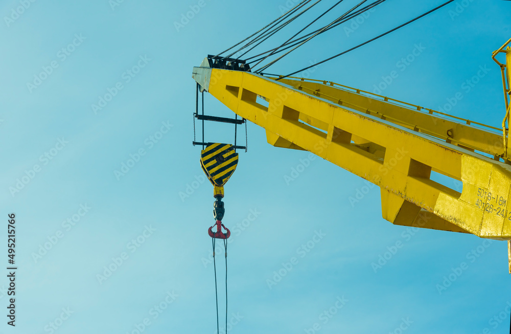 construction yellow crane jib against blue sky construction yellow crane jib against blue sky