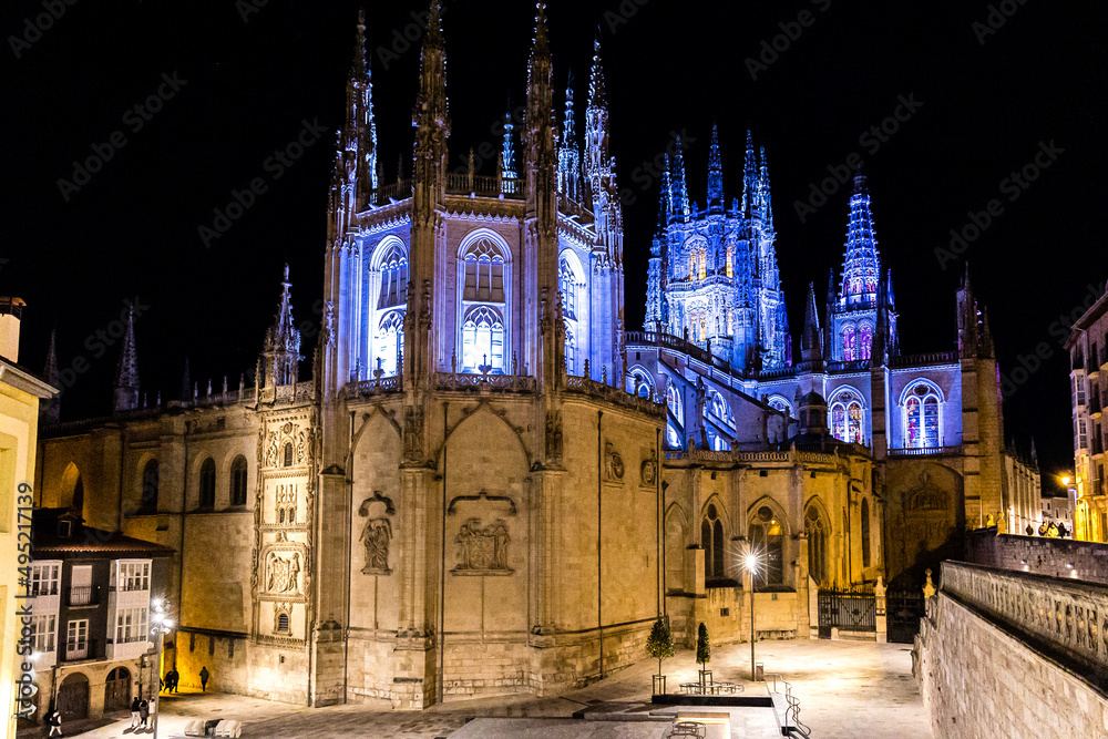 Fototapeta premium Burgos Cathedral with people and tourists walking past in the square next to the Cathedral of Saint Mary, in Burgos, Spain