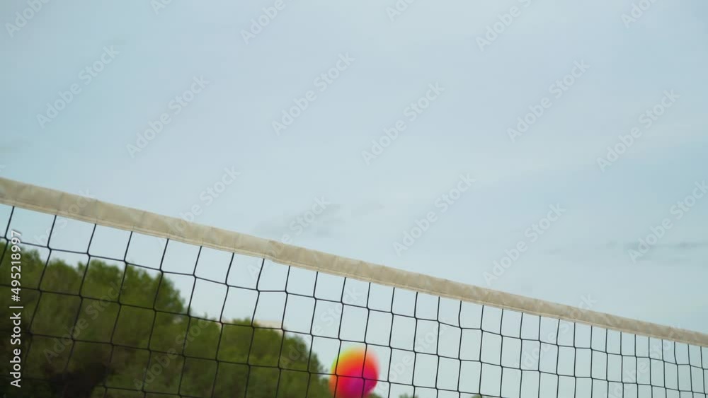 Looking up beach volleyball net, clear sky background, rainbow coloured