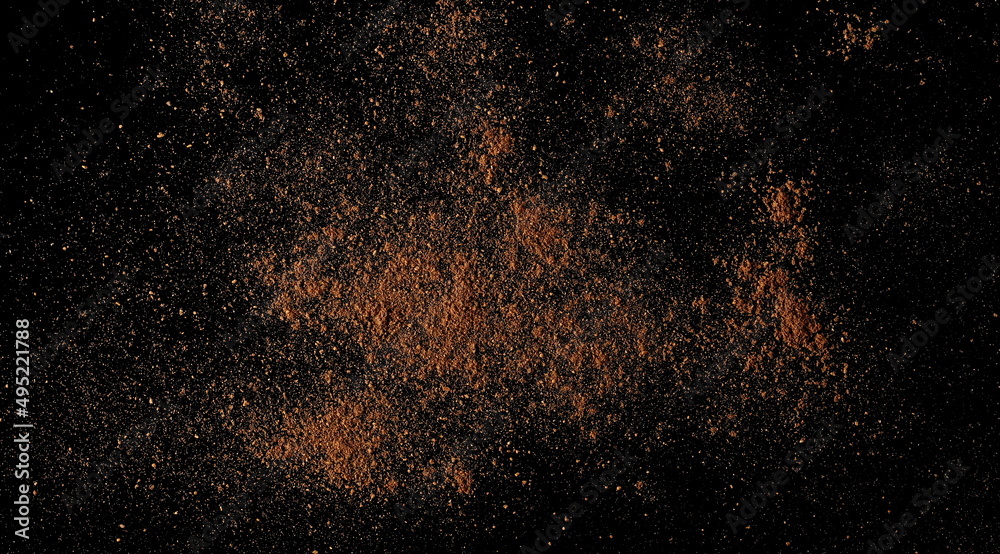 Ground, milled nutmeg powder isolated on black, top view Ground, milled nutmeg powder isolated on black, top view